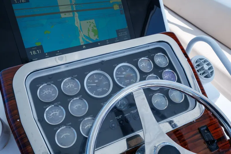 Loca Louise Yacht Photos Pics Control panel of a 2002 Hatteras 50 Convertible yacht with navigation display.