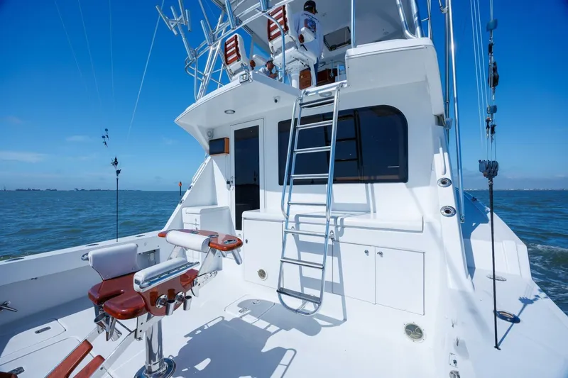 Loca Louise Yacht Photos Pics 2002 Hatteras 50 Convertible yacht with fishing chairs and ladder on open sea.