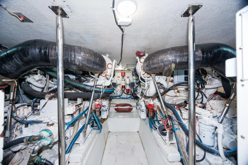 Loca Louise Yacht Photos Pics Engine room of 2002 Hatteras 50 Convertible yacht, showcasing mechanical components and piping.