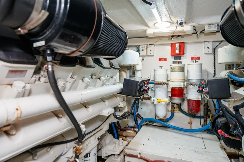 Loca Louise Yacht Photos Pics Engine room of 2002 Hatteras 50 Convertible yacht, showcasing mechanical components and systems.
