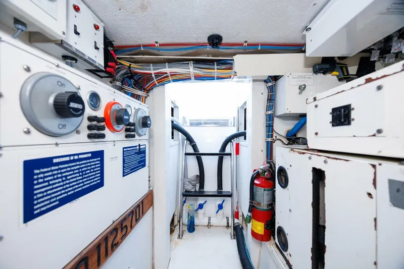 Loca Louise Yacht Photos Pics Engine room of a 2002 Hatteras 50 Convertible yacht, featuring control panels and wiring.