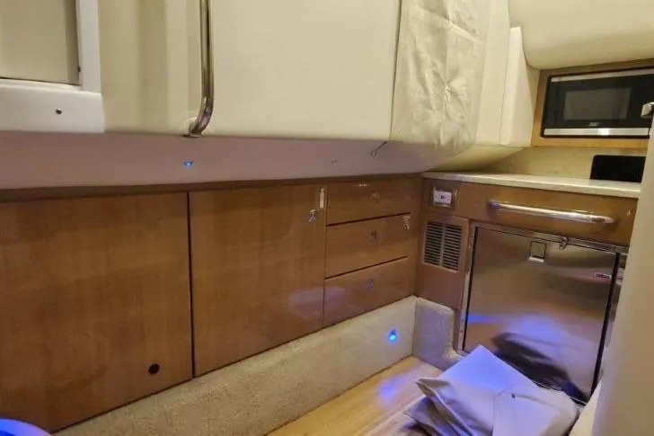  Yacht Photos Pics 2017 Formula 350 Crossover Bowrider interior with wood cabinetry and modern appliances.