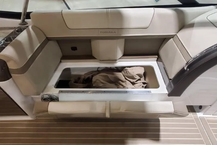  Yacht Photos Pics 2017 Formula 350 Crossover Bowrider interior with open storage compartment and beige seating.