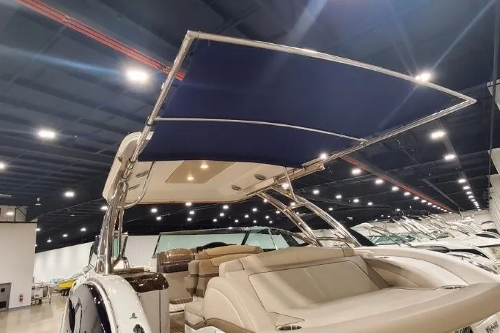  Yacht Photos Pics 2017 Formula 350 Crossover Bowrider with blue canopy in showroom setting.