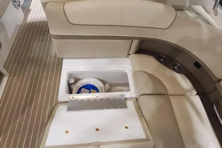  Yacht Photos Pics 2017 Formula 350 Crossover Bowrider interior with storage compartment open, showcasing beige seating.