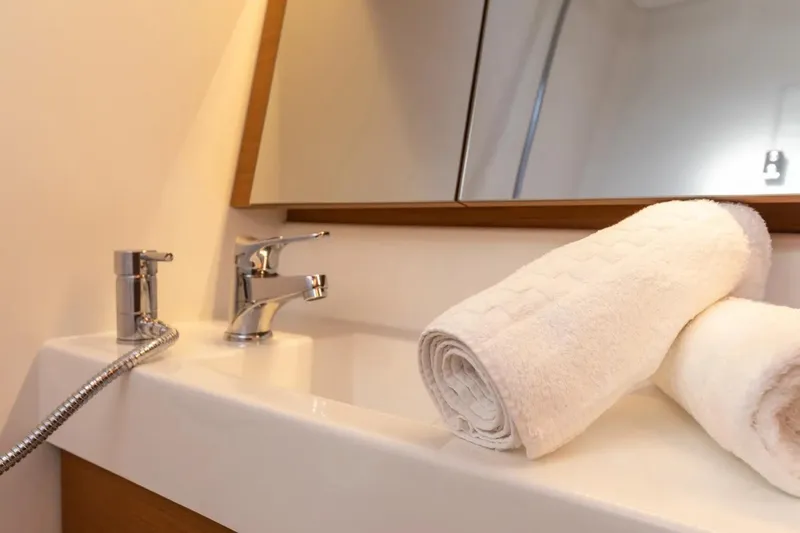  Yacht Photos Pics Bathroom sink with rolled towels on Jeanneau Sun Odyssey 410, 2021 model.