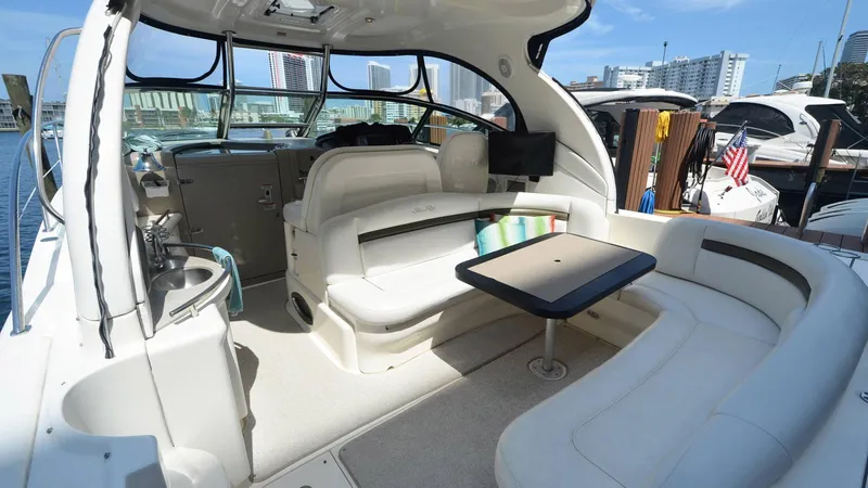 Ma Folie III Yacht Photos Pics 2007 Sea Ray 40 Sundancer yacht interior with seating and table, docked at marina.