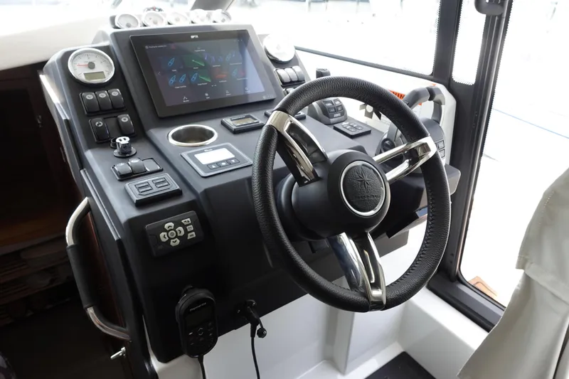 Somedays Here Yacht Photos Pics Helm of 2021 Jeanneau NC 37 boat with modern controls and steering wheel.