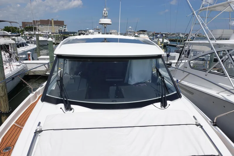 Somedays Here Yacht Photos Pics 2021 Jeanneau NC 37 docked at a marina, showcasing sleek design and modern features.