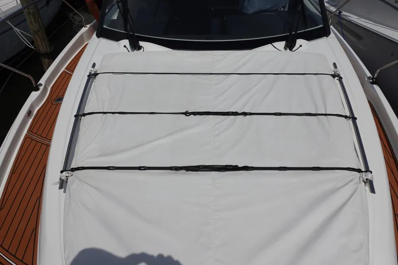 Somedays Here Yacht Photos Pics 2021 Jeanneau NC 37 boat with covered deck and wooden accents.