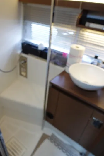 Somedays Here Yacht Photos Pics Interior of 2021 Jeanneau NC 37 boat bathroom with sink and shower area.