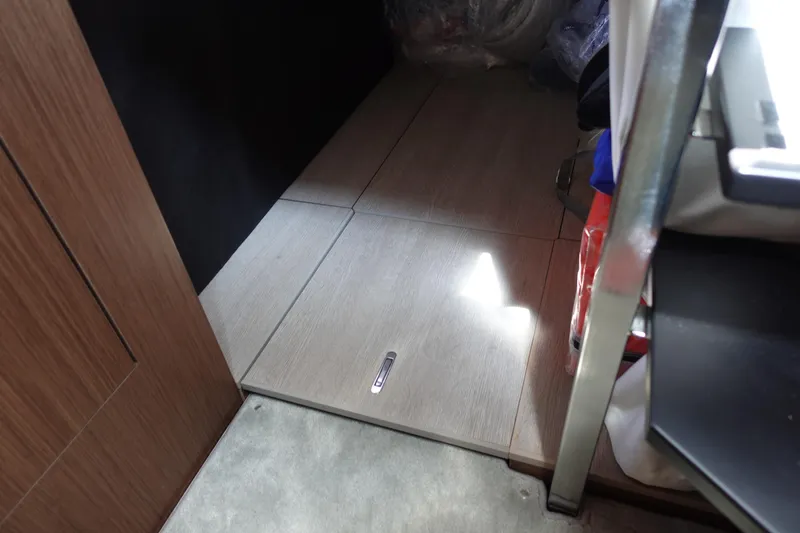 Somedays Here Yacht Photos Pics Interior view of 2021 Jeanneau NC 37 boat, featuring wooden flooring and storage area.