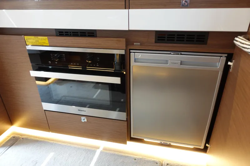 Somedays Here Yacht Photos Pics Modern kitchen appliances in 2021 Jeanneau NC 37 yacht, featuring Miele oven and fridge.