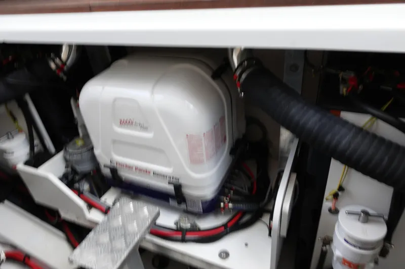 Somedays Here Yacht Photos Pics Engine compartment of 2021 Jeanneau NC 37 boat, featuring generator and wiring.