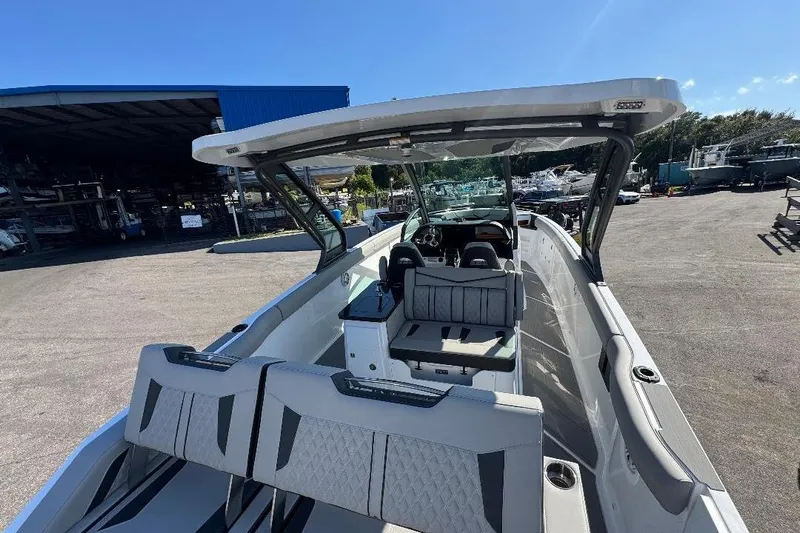  Yacht Photos Pics 2026 Monterey Elite 30 OB boat interior with seating and helm, docked outdoors.