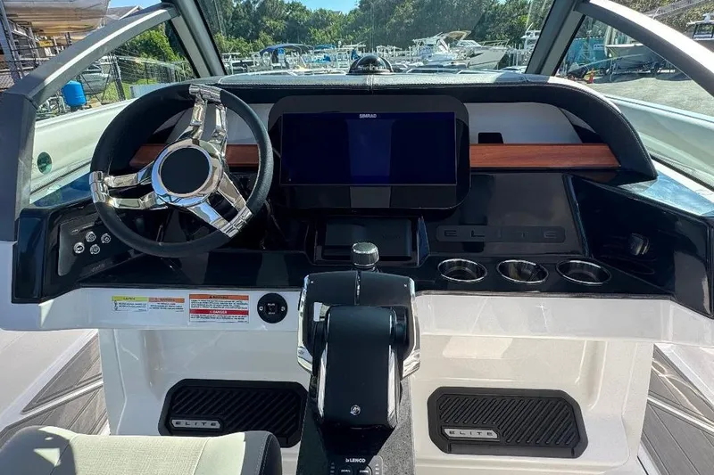  Yacht Photos Pics 2026 Monterey Elite 30 OB boat dashboard with steering wheel and digital display.