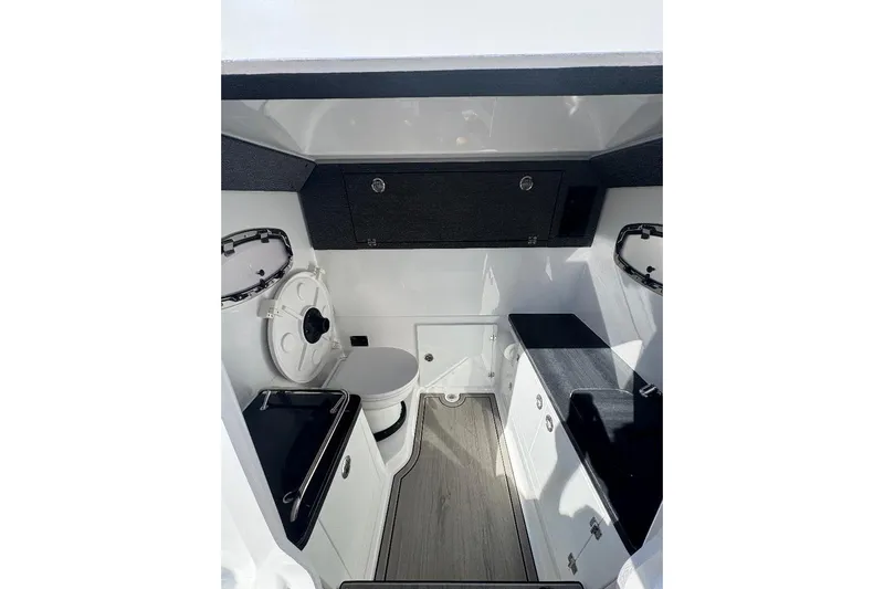  Yacht Photos Pics Interior of 2026 Monterey Elite 30 OB boat, featuring modern cabinetry and compact design.