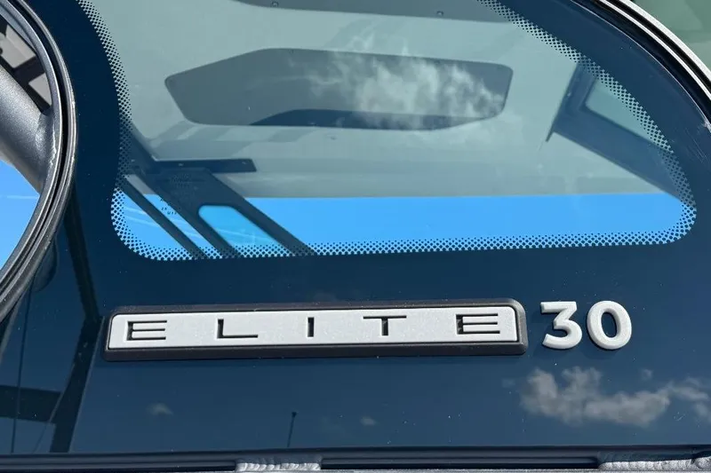  Yacht Photos Pics 2026 Monterey Elite 30 OB boat logo on windshield with sky reflection.