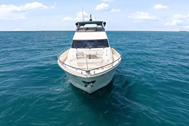  Yacht Photos Pics 2016 Marquis 720 Fly Bridge yacht cruising on open blue sea.