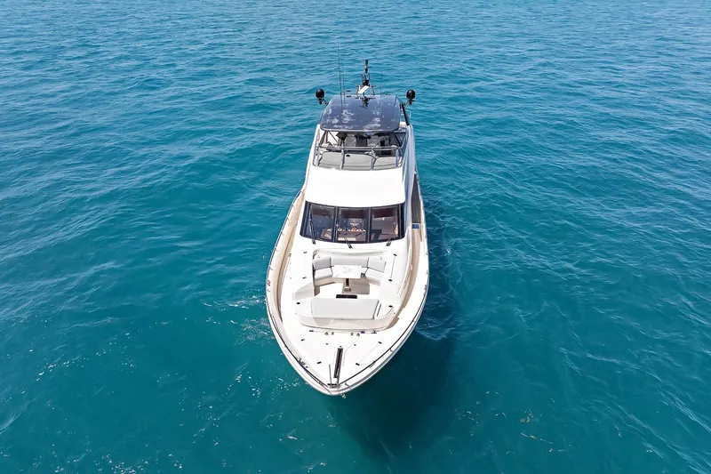  Yacht Photos Pics Luxury Marquis 720 Fly Bridge yacht cruising on clear blue ocean waters, 2016 model.