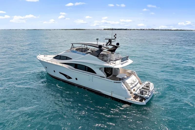  Yacht Photos Pics Luxury 2016 Marquis 720 Fly Bridge yacht cruising on clear blue ocean waters.