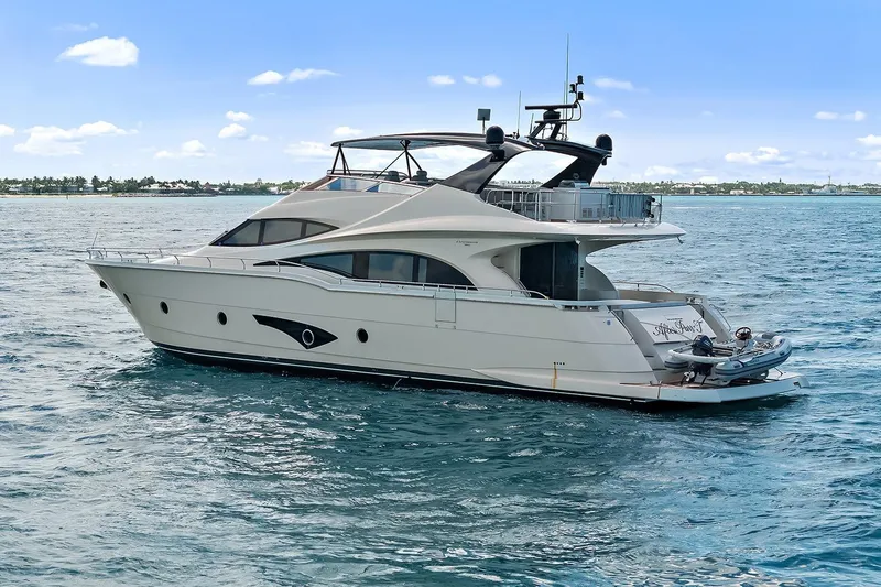  Yacht Photos Pics Luxury 2016 Marquis 720 Fly Bridge yacht cruising on open water.