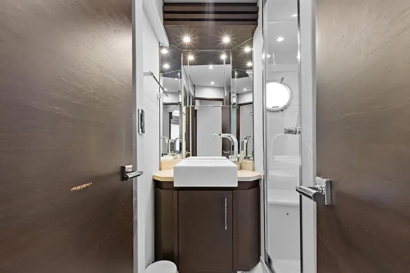  Yacht Photos Pics guest bathroom interior on 2016 Marquis 720 Fly Bridge yacht, featuring modern fixtures and elegant design.