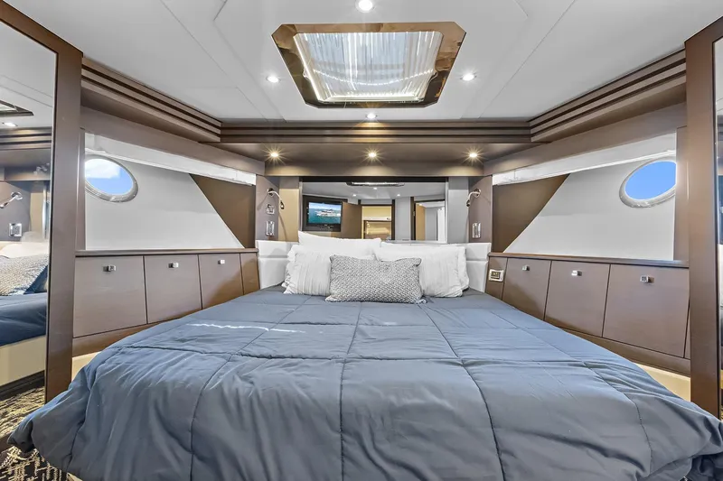  Yacht Photos Pics VIP bedroom interior of 2016 Marquis 720 Fly Bridge offers queen sized bed and private bathroom