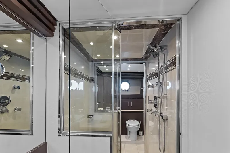  Yacht Photos Pics Luxurious bathroom on 2016 Marquis 720 Fly Bridge yacht with modern shower and porthole window.