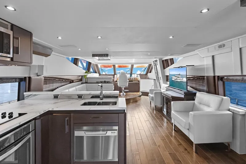  Yacht Photos Pics Luxurious interior of 2016 Marquis 720 Fly Bridge yacht with modern kitchen and seating area.