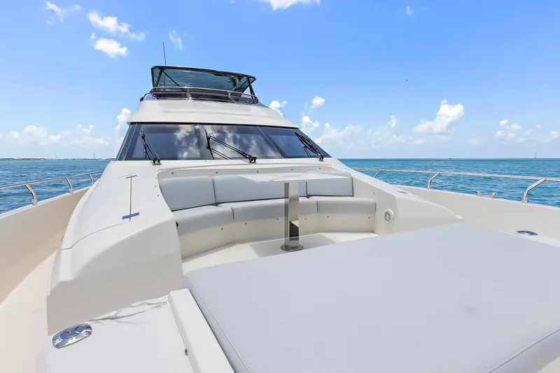  Yacht Photos Pics Luxury Marquis 720 Fly Bridge yacht, 2016 model, cruising on a clear blue ocean.