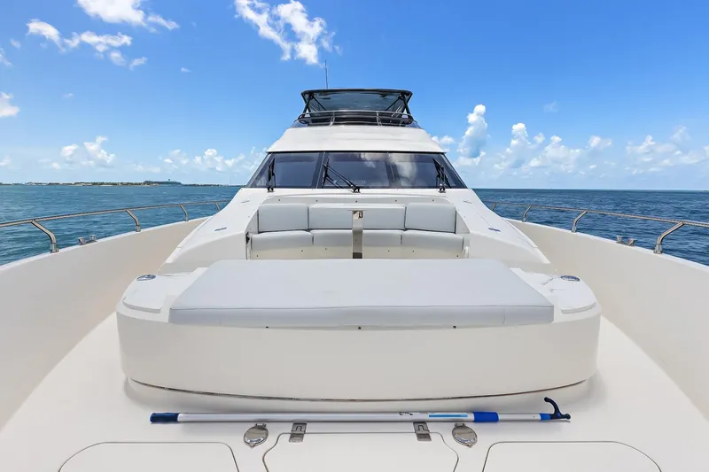  Yacht Photos Pics 2016 Marquis 720 Fly Bridge yacht on open sea, featuring spacious deck and seating.