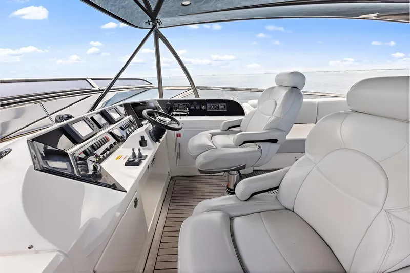  Yacht Photos Pics Luxurious 2016 Marquis 720 Fly Bridge yacht upper helm and plush seating.