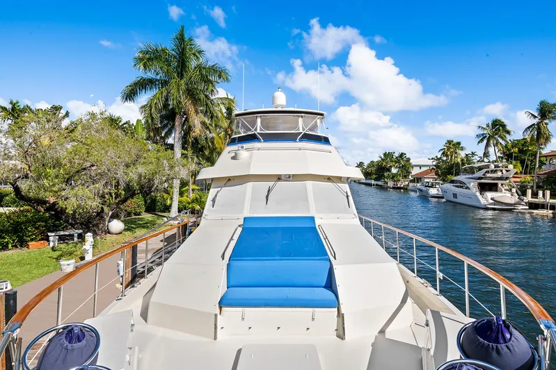  Yacht Photos Pics 1989 Hatteras 70 Motor Yacht docked in a scenic canal with palm trees.
