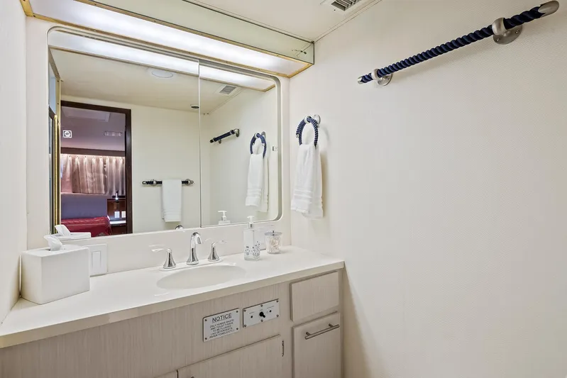  Yacht Photos Pics Bathroom vanity in 1989 Hatteras 70 Motor Yacht with mirror and towel rack.