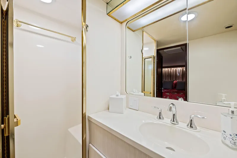  Yacht Photos Pics Bathroom interior of 1989 Hatteras 70 Motor Yacht with sink, mirror, and shower.