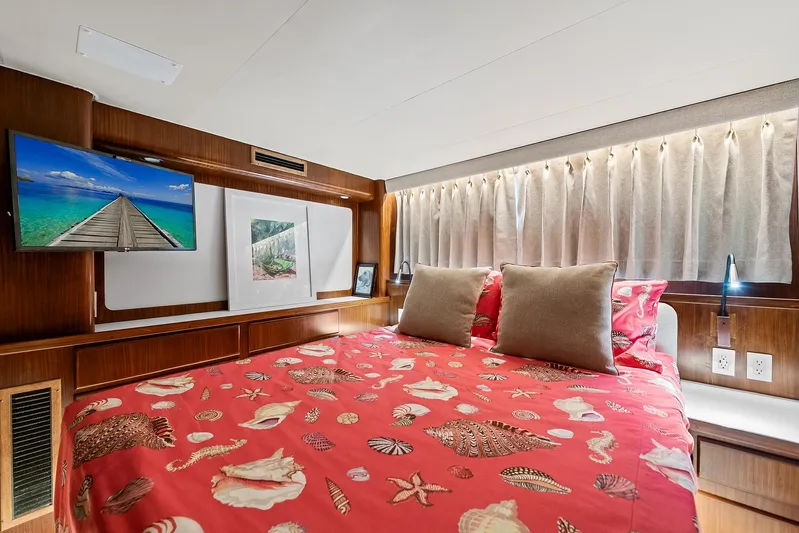  Yacht Photos Pics Luxurious bedroom in 1989 Hatteras 70 Motor Yacht with red seashell bedding.