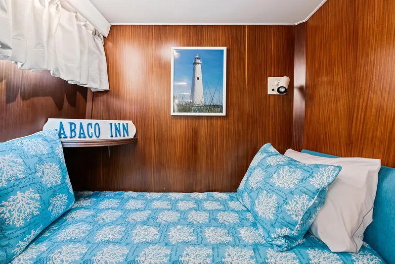  Yacht Photos Pics Cozy cabin bedroom in 1989 Hatteras 70 Motor Yacht with lighthouse decor.