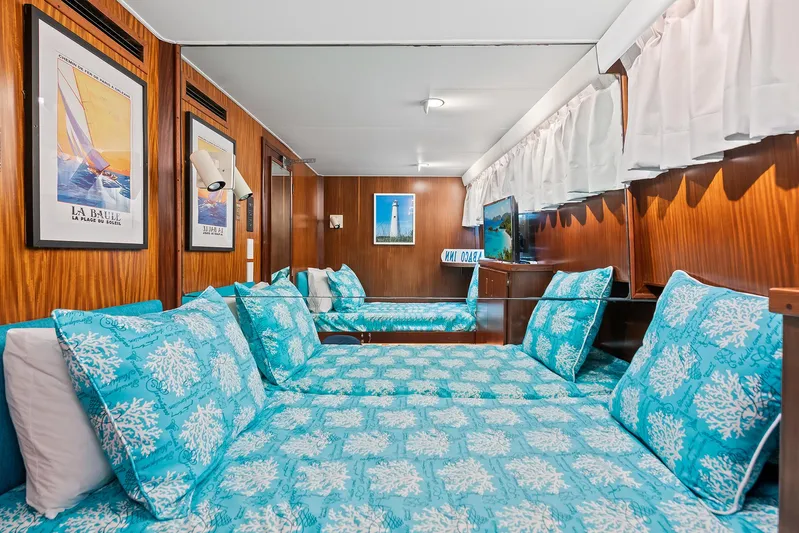  Yacht Photos Pics Interior cabin of 1989 Hatteras 70 Motor Yacht with blue bedding and nautical decor.