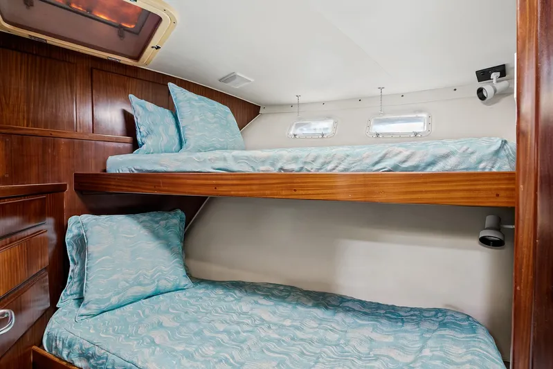  Yacht Photos Pics 1989 Hatteras 70 Motor Yacht cabin with bunk beds and wooden interior.
