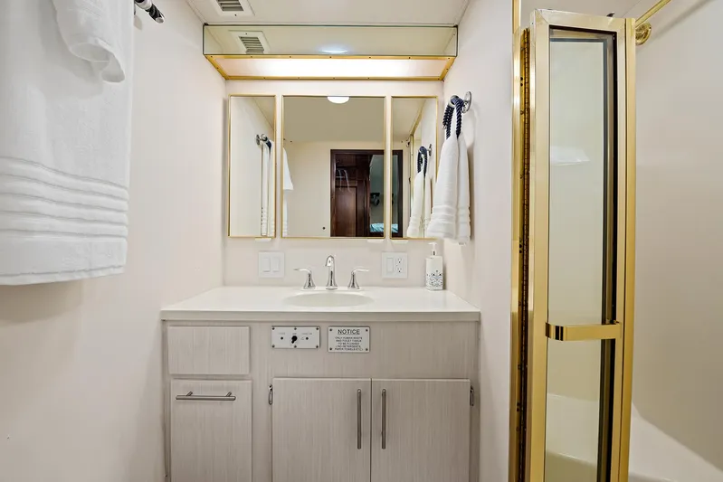  Yacht Photos Pics Bathroom vanity and shower in 1989 Hatteras 70 Motor Yacht.