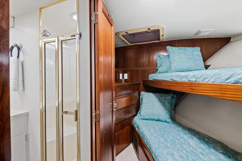 Yacht Photos Pics 1989 Hatteras 70 Motor Yacht cabin with bunk beds and en-suite bathroom.