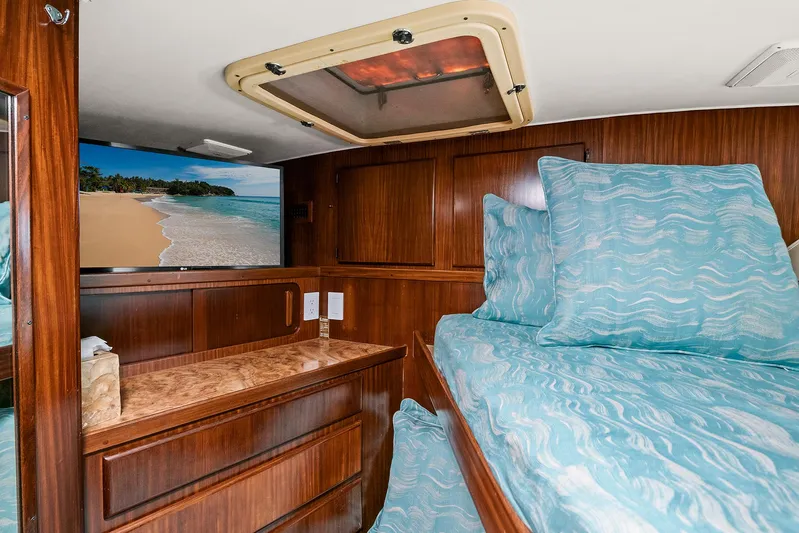  Yacht Photos Pics Interior cabin of 1989 Hatteras 70 Motor Yacht with TV and wooden furnishings.