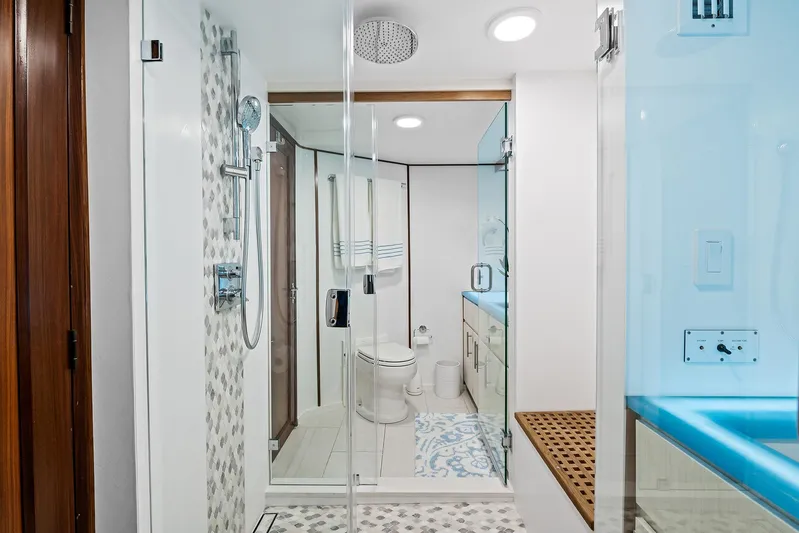  Yacht Photos Pics Modern bathroom on a 1989 Hatteras 70 Motor Yacht with glass shower and stylish decor.