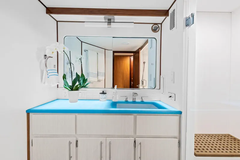  Yacht Photos Pics 1989 Hatteras 70 Motor Yacht bathroom with blue countertop and modern fixtures.
