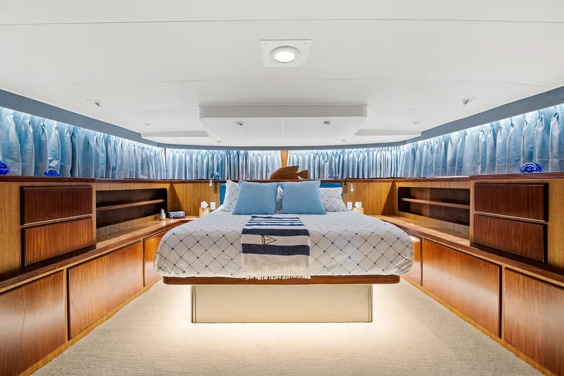  Yacht Photos Pics Luxurious master bedroom on 1989 Hatteras 70 Motor Yacht with elegant wood cabinetry.