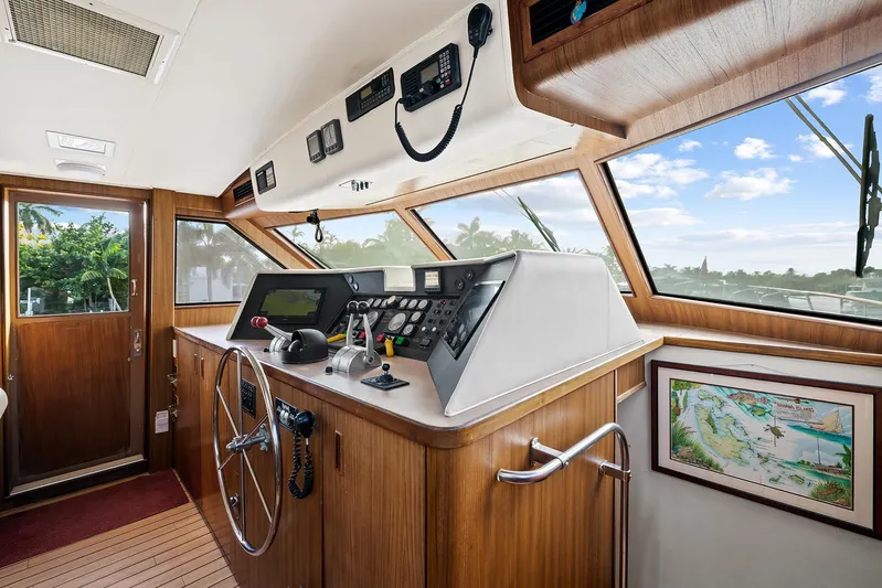  Yacht Photos Pics Interior helm of 1989 Hatteras 70 Motor Yacht with navigation equipment and panoramic windows.