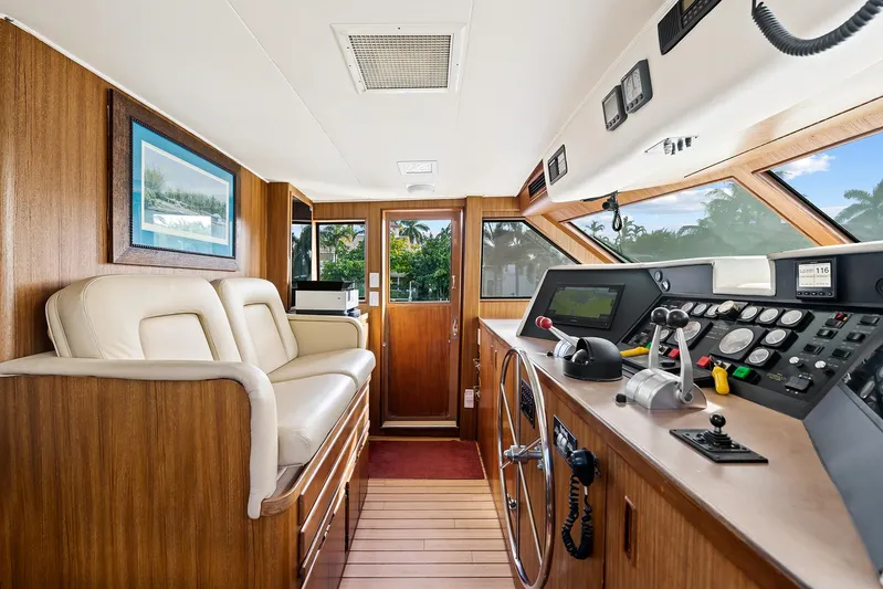  Yacht Photos Pics 1989 Hatteras 70 Motor Yacht helm with modern navigation equipment and comfortable seating.