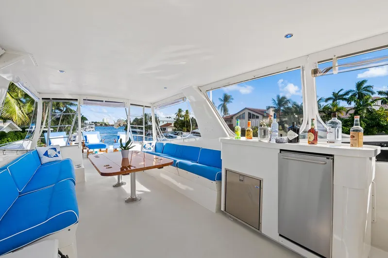  Yacht Photos Pics 1989 Hatteras 70 Motor Yacht interior with blue seating and bar area.