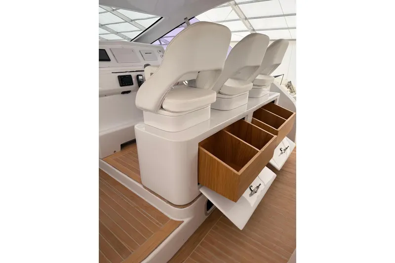  Yacht Photos Pics Luxury yacht interior with white seats and wooden storage drawers, Zeta Elle 20, 2023 model.